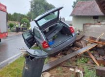 Auto nárazem částečně zbořilo betonový plot u rodinného domu, cestující utrpěl zranění