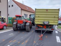 Traktor s přívěsem za sebou se převrátil na bok a zatarasil celou vozovku